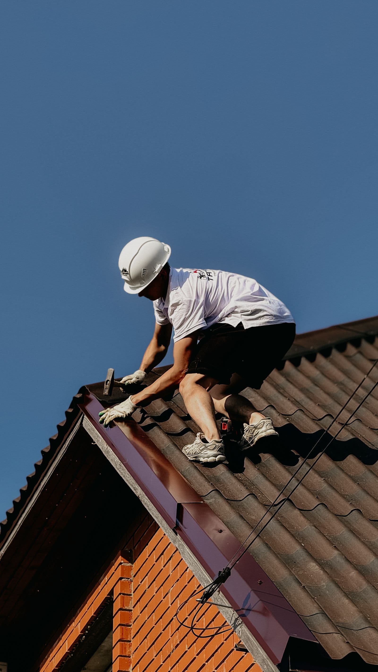 Workers beside a brick chimney